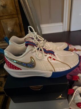 Nike Kids White Sneakers with Blue, Red and Gold Accents
